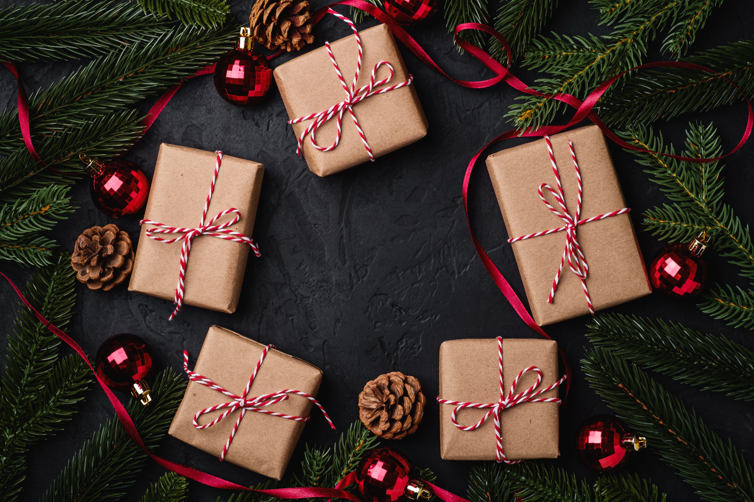 Kraft-wrapped gifts with red ribbon and ornaments