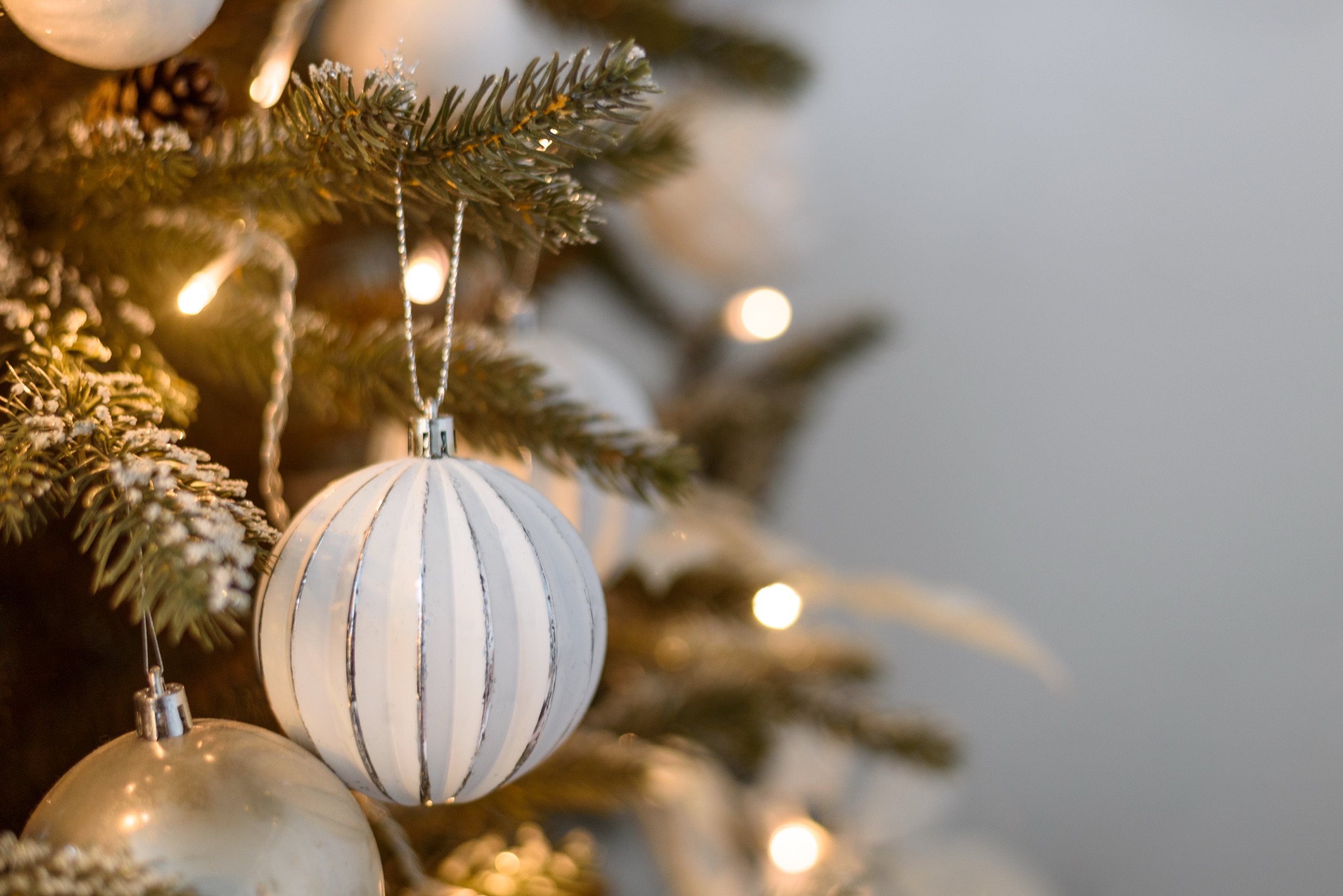 White striped ornament in warm candle-glow